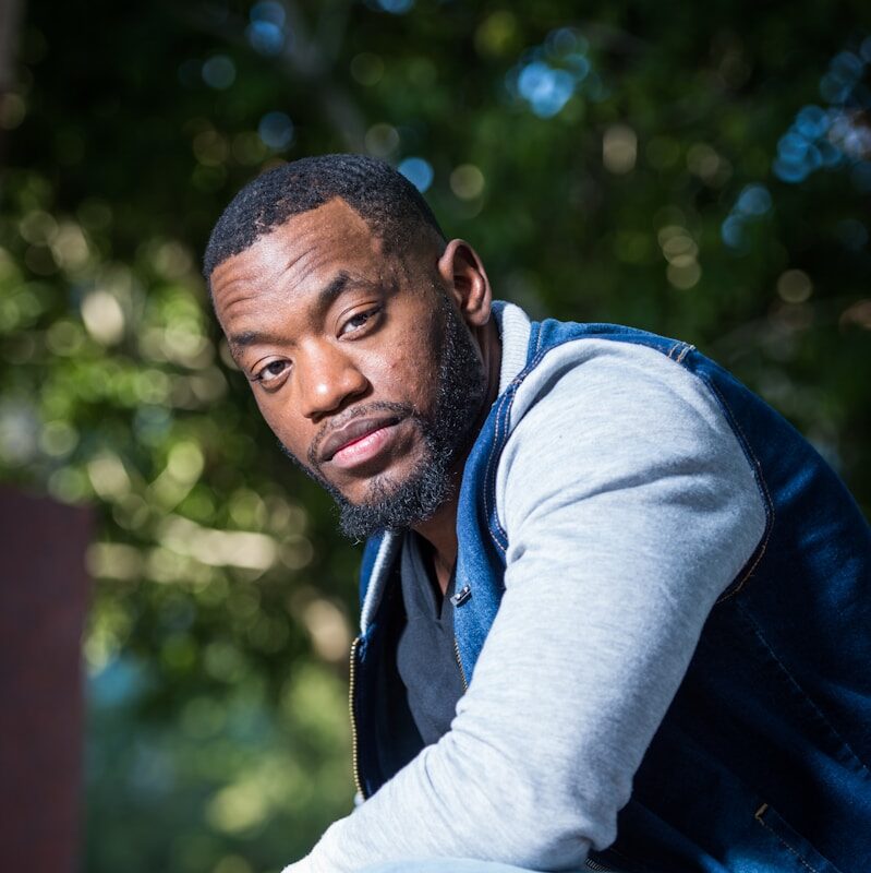 man wearing blue zip-up jacket